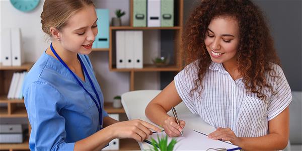 Medical assistant helping a patient